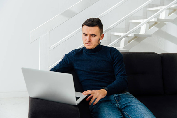 Pensive man working on laptop at home. - Fotoğraf, Görsel