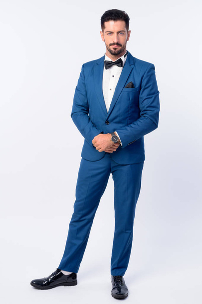 Full body shot of young handsome bearded businessman in blue suit - Photo, image