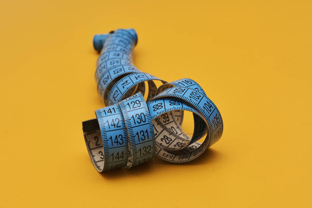 measuring tape on yellow background  - Foto, immagini