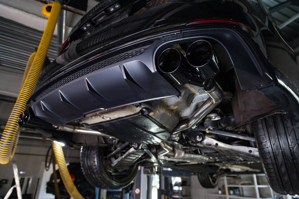 Bottom view of the car on a bifurcated exhaust system, rear bump - Photo, Image