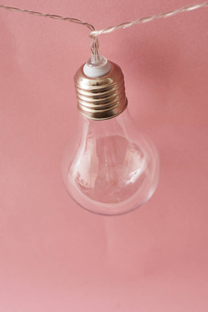 vintage bulb lamp on pink background , close view - Fotó, kép