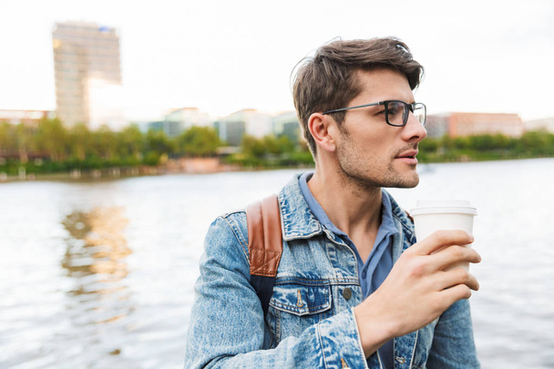 Handsome young man dressed casually spending time outdoors - Photo, Image