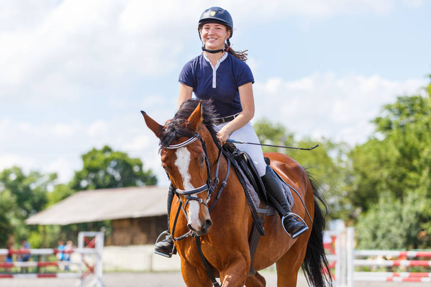 Young female horse rider on equestrian sport event - Fotó, kép