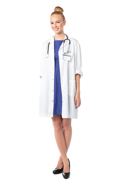 Relaxed female doctor standing with crossed legs - 写真・画像