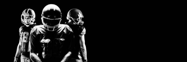 Young American football players standing in helmets - Foto, afbeelding