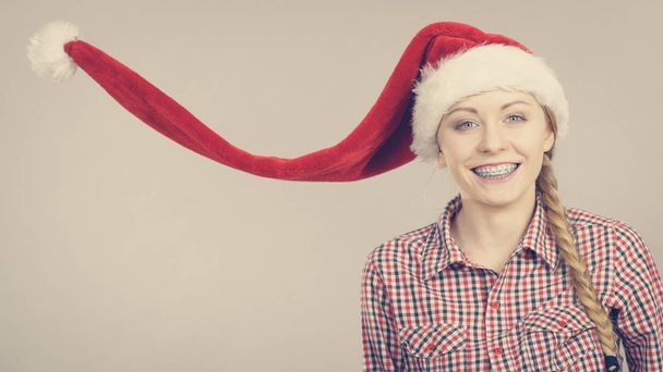 Happy woman wearing Santa Claus helper hat - Fotografie, Obrázek