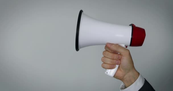 hand with megaphone on gray background with copy space - Footage, Video