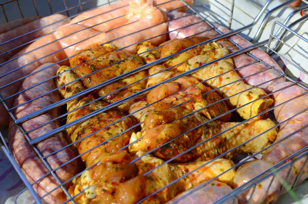 Marinated chicken legs on hot BBQ charcoal field grill - Photo, Image