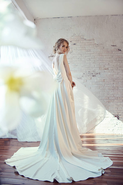 Luxurious white wedding dress on the girl's body. New collection - Foto, Bild