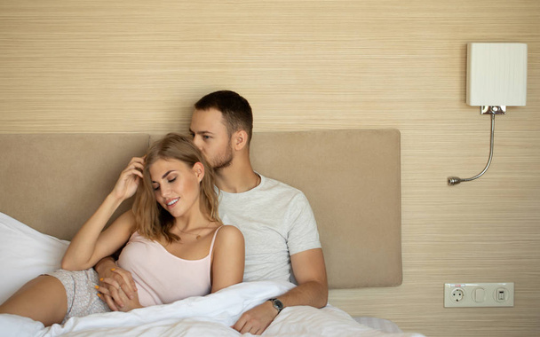 Lovely couple resting in bed in morning - Photo, image