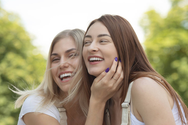 Image of two young happy women friends standing outdoor. Best friends. - Foto, imagen