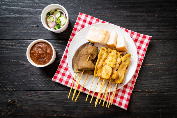 Pork Satay with your Peanut Sauce  and pickles which are cucumbe - Photo, Image