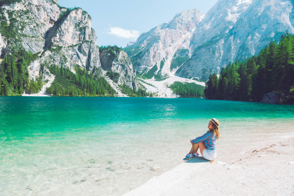woman sitting on the beach of mountain lake summer season - Foto, Imagem