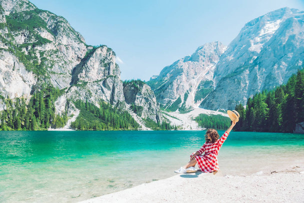 Nainen istuu rannalla vuoren järven kesäkaudella
 - Valokuva, kuva