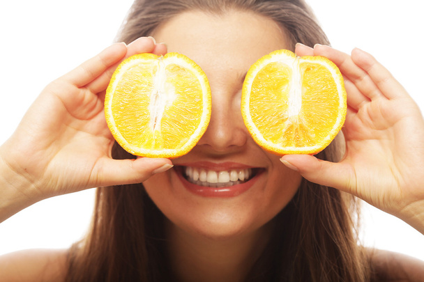 Funny girl holding oranges over eyes - Zdjęcie, obraz