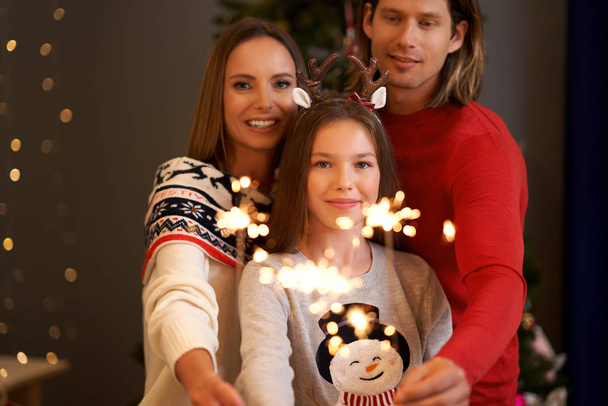 Bella famiglia che celebra il Natale e che tiene scintille
 - Foto, immagini