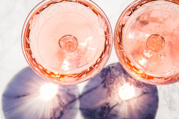Two crystal stemmed glasses with rose wine - Fotoğraf, Görsel