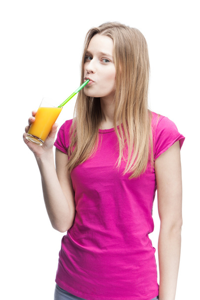 Young beautiful blond woman drinking orange juice - Fotó, kép