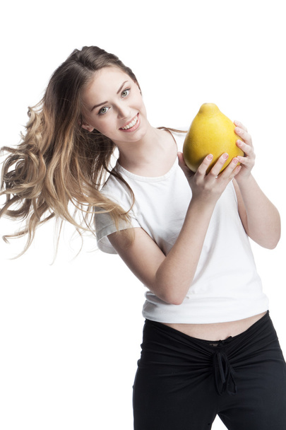 Young beautiful brunette woman holding pomelo - 写真・画像