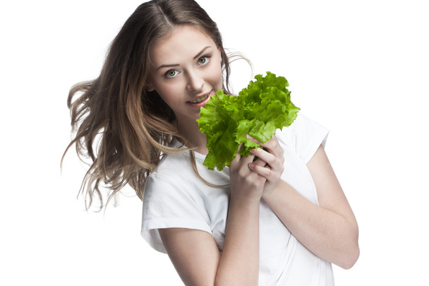 Young beautiful brunette woman holding salad - Фото, изображение