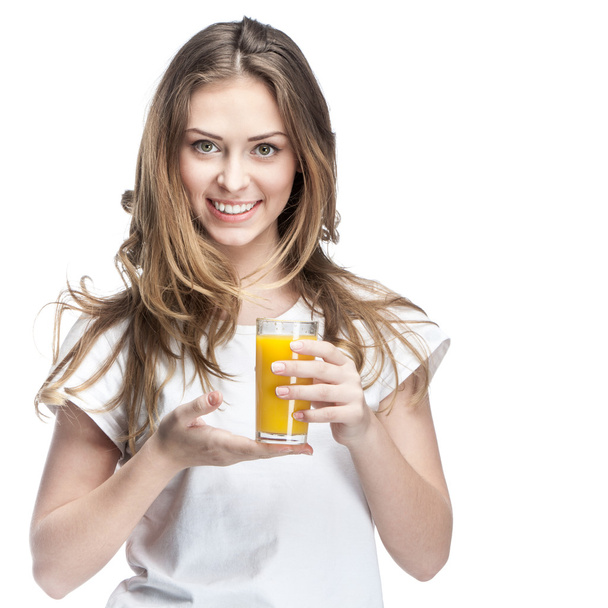 Young woman holding glass of orange juice - 写真・画像