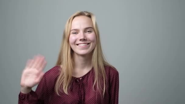 Fiatal kaukázusi szőke nő integetett kezét, üdvözölve a barátja. - Felvétel, videó