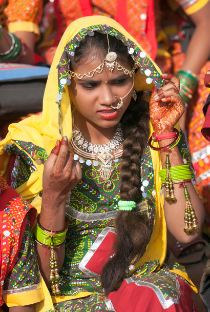 An unidentified girl in colorful ethnic attire attends at the P - Photo, Image