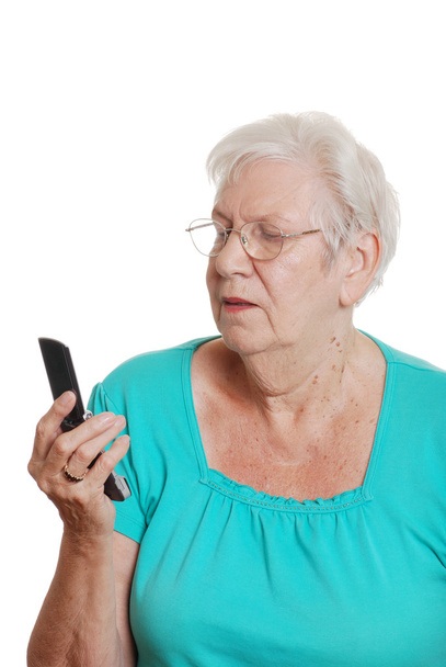 Senior woman trying to use a cell phone - Photo, Image