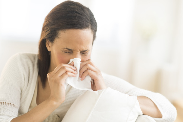 Woman Blowing Nose With Tissue At Home - Foto, immagini