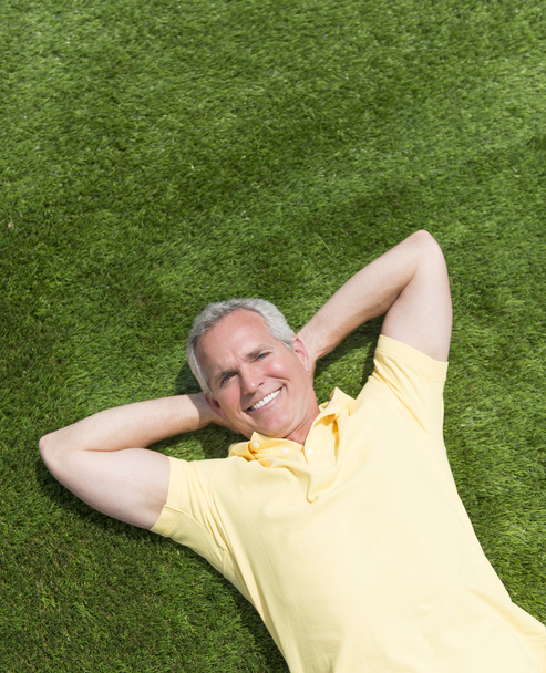 Portrait Of Happy Man Lying On Grass - Foto, Imagen