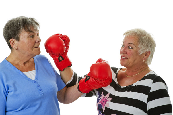 Two female seniors with red boxing glove - Photo, Image
