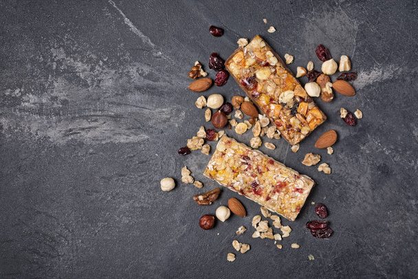 Granola bar with dried cranberries and nuts for healthy nutrition - Fotó, kép