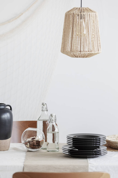 Close-up of designed beige lamp above table - Photo, image