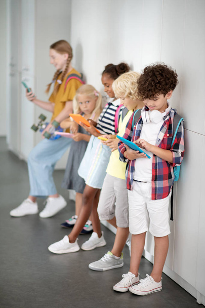 Children with gadgets spending their break on playing games - Φωτογραφία, εικόνα