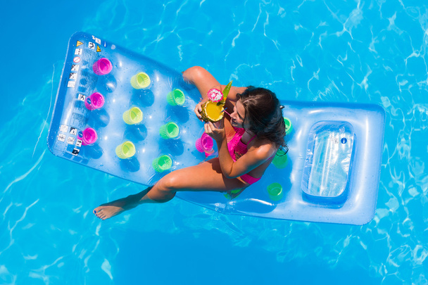 A girl is relaxing in a swimming pool - Zdjęcie, obraz