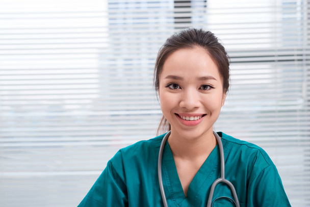 Female doctor smiling at camera, office interior  - Φωτογραφία, εικόνα