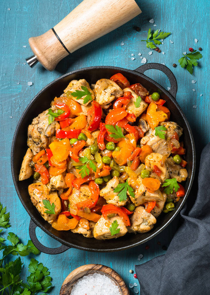 Chicken Stir fry with vegetables on blue table. - Foto, immagini