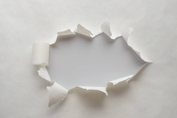 A hole in old paper with the sides torn off. - Foto, Imagem