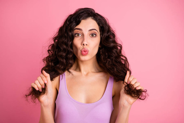 Photo of cheerful nice cute charming fascinating girl kissing you through camera holding her hands while isolated with pink background - Zdjęcie, obraz