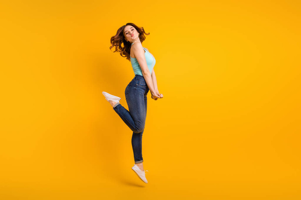 Full length photo of jumping high lady sending boyfriend air kisses wear casual outfit isolated yellow background - 写真・画像