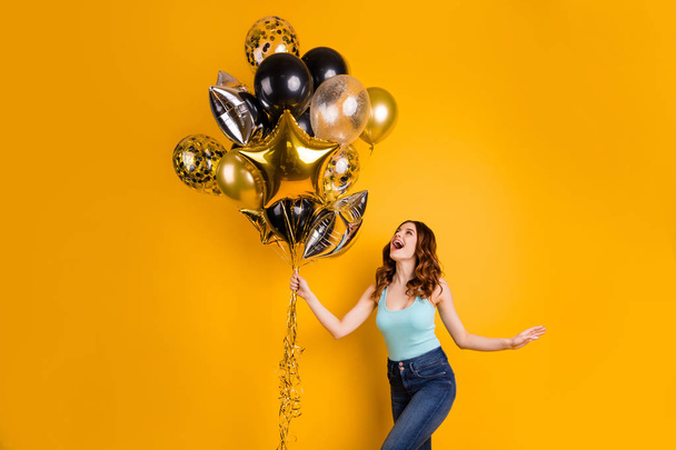 Photo of pretty lady having best weekend with flying air ballons in hands wear tank-top isolated yellow background - Φωτογραφία, εικόνα