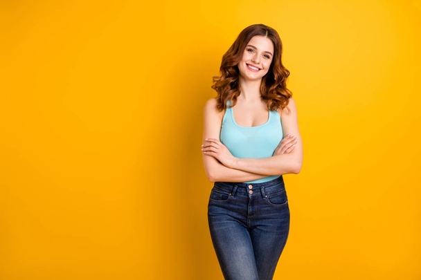Photo of cute nice cheerful gorgeous lovely girlfriend with hands folded smiling cheerfully wearing turquoise tank-top jeans denim isolated with yellow vibrant color background - Foto, Bild