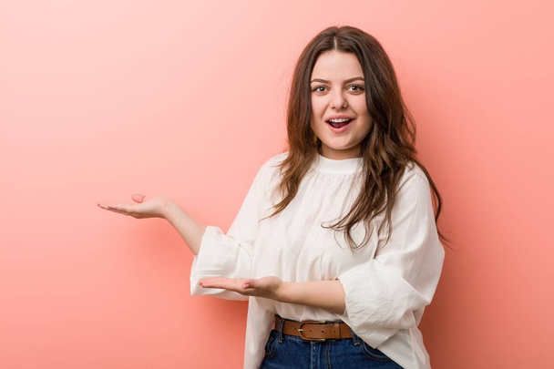 Young caucasian curvy woman standing against pink background - Photo, Image