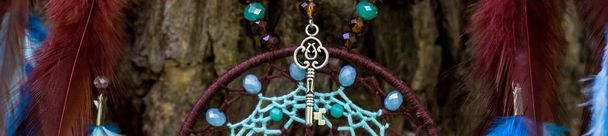 banner of Handmade dream catcher with feathers threads and beads rope hanging - Photo, Image