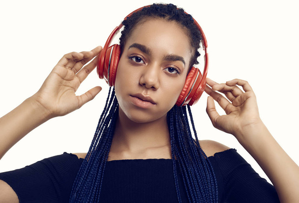 Beautiful african brunette teenage girl with dreadlocks listenin - Фото, изображение