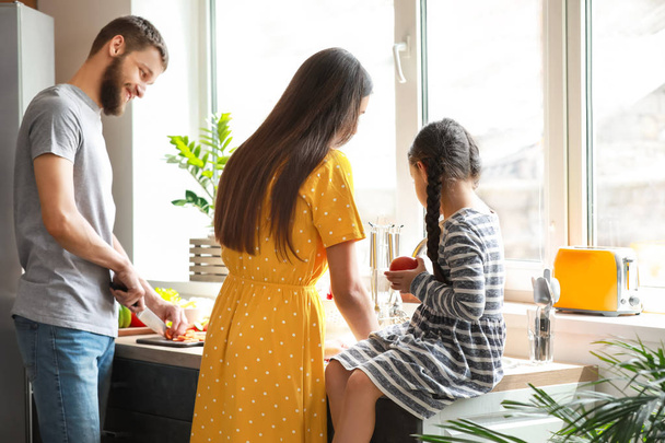 Young family cooking together in kitchen - Photo, Image