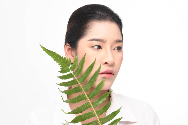 Beautiful woman holding green plant. - Photo, Image