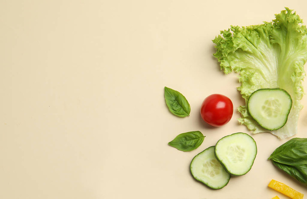 Flat lay composition with fresh salad ingredients on beige background, space for text - Fotografie, Obrázek