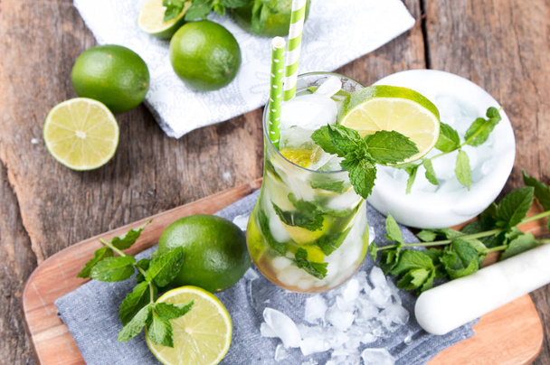 Mohito lime drinks on wooden with blur beach background. Fresh drinks with fruits on wood. Summer concept - Fotoğraf, Görsel