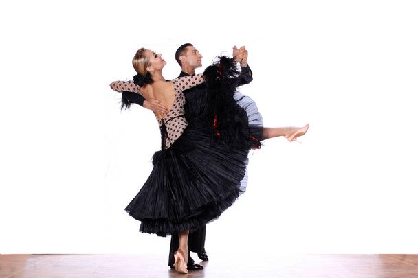 Latino dancers in ballroom against white background - Valokuva, kuva
